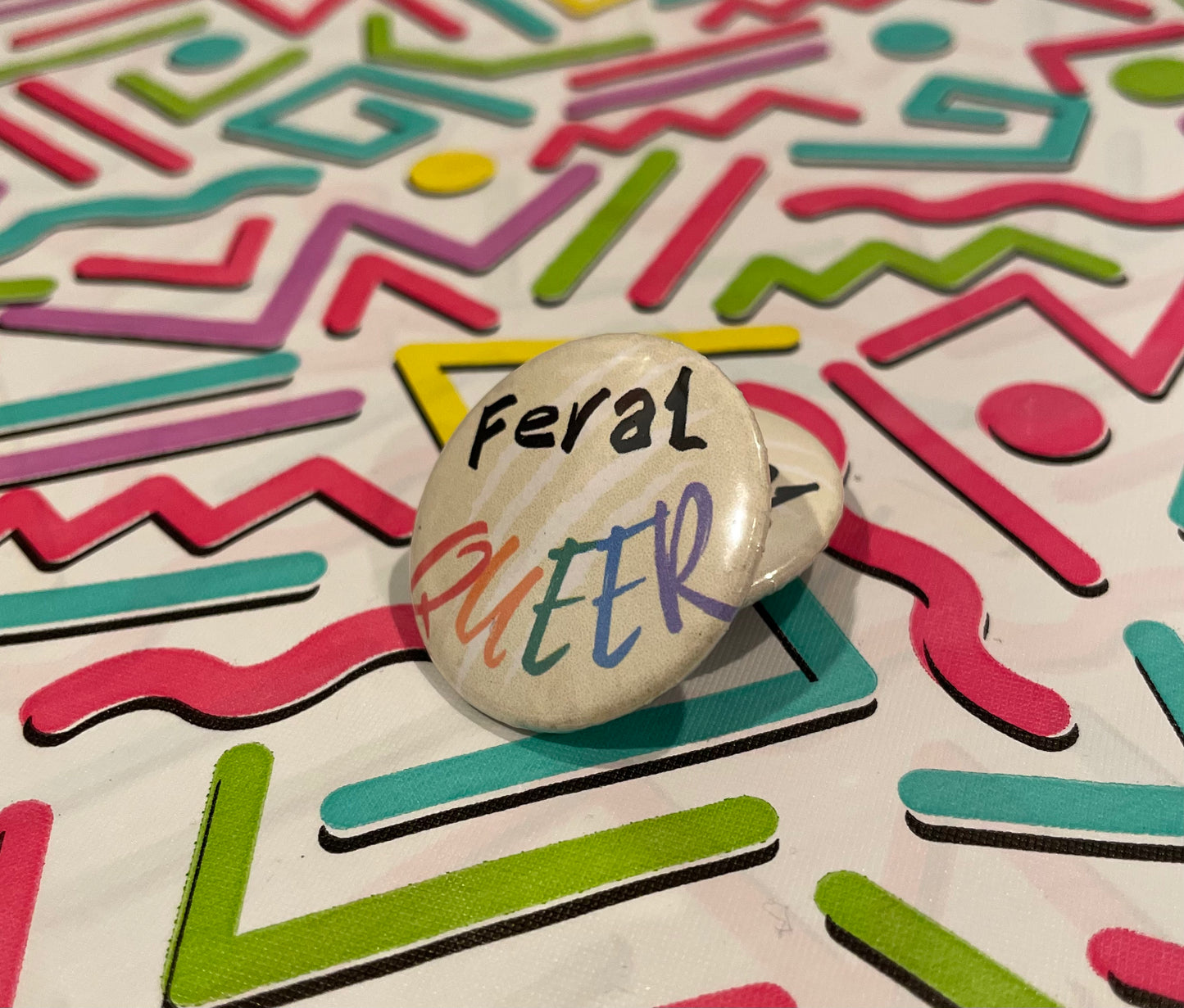 Feral Queer button with a bold and playful design