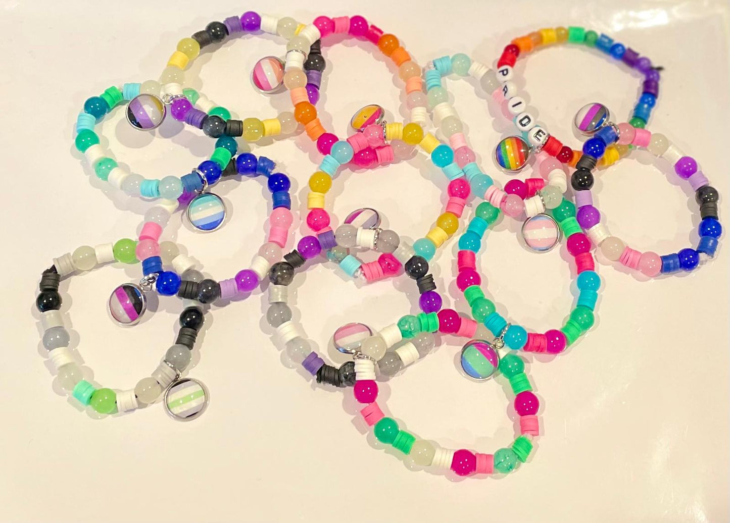 Colorful beaded bracelets on a white surface
