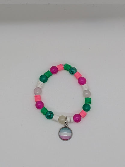 Colorful beaded bracelet with a circular charm on a white background