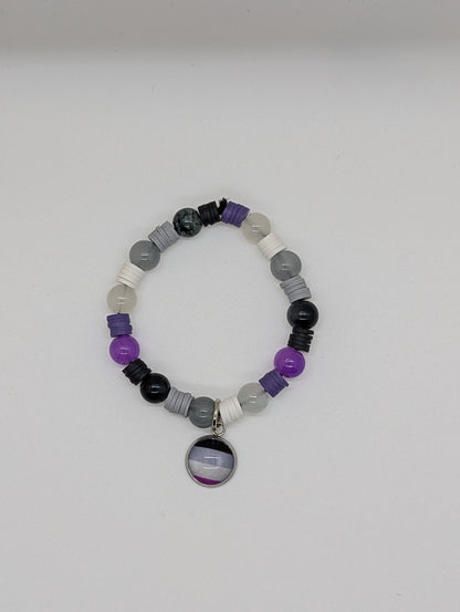 Beaded bracelet with a circular charm on a white background
