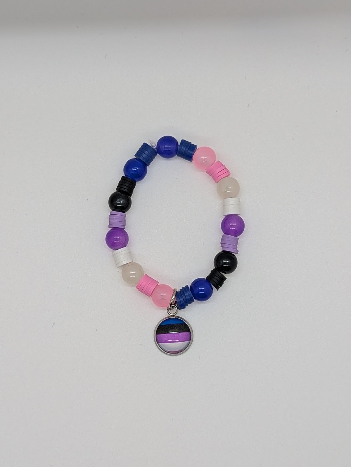 Colorful beaded bracelet with a circular charm featuring a rainbow design on a white background.