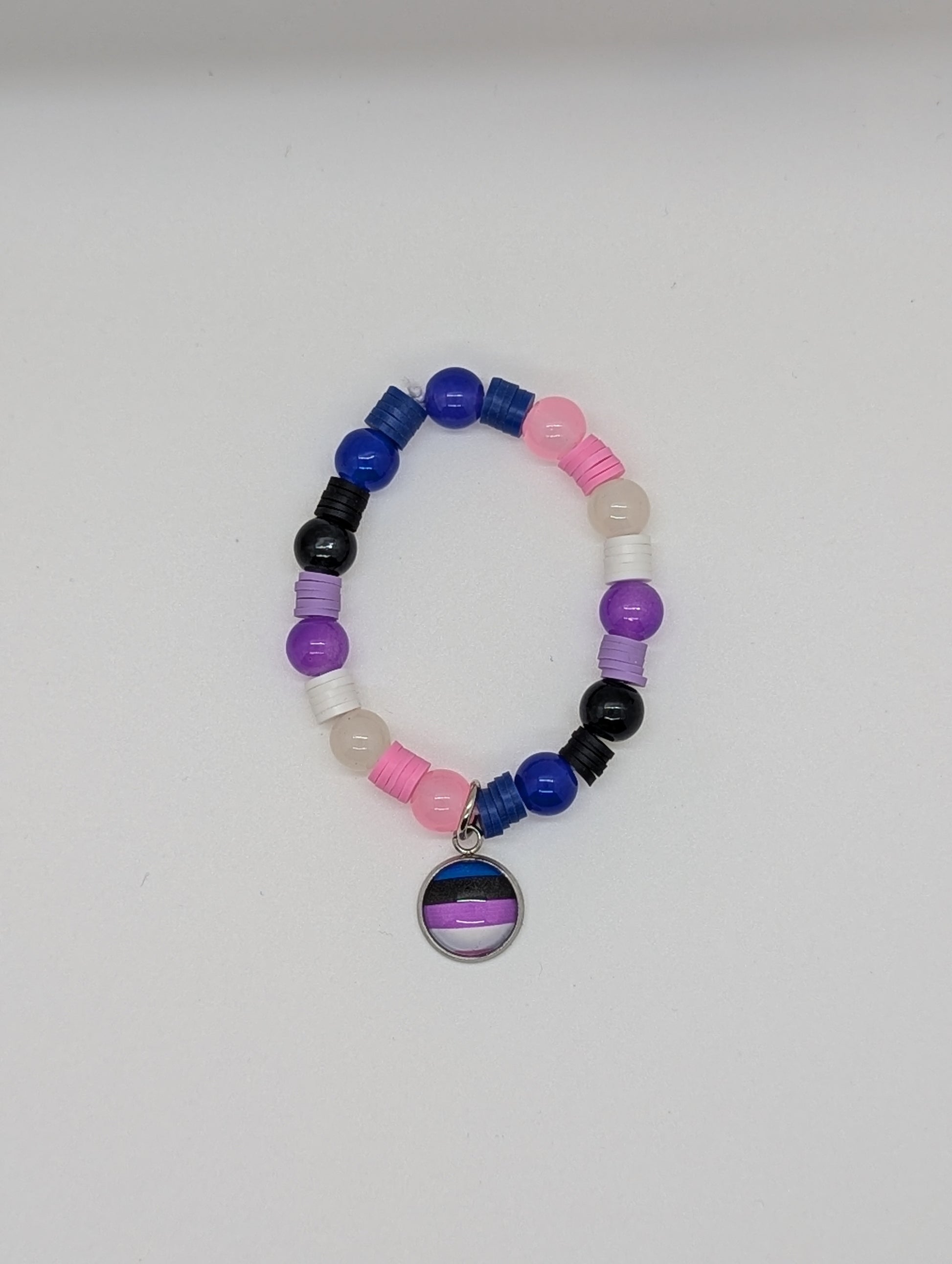 Colorful beaded bracelet with a circular charm featuring a rainbow design on a white background.