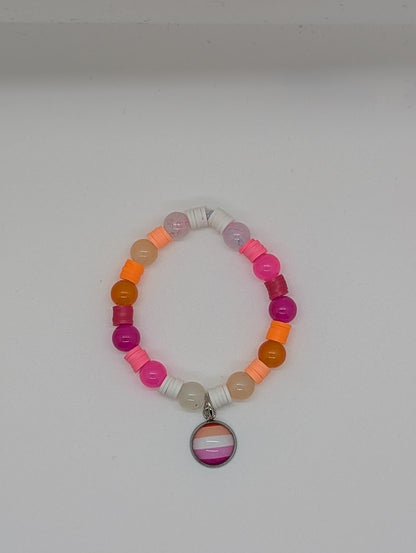 Colorful beaded bracelet with a circular charm on a white background