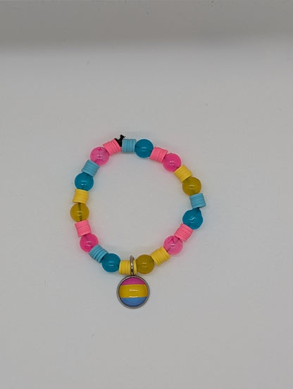 Colorful beaded bracelet with a rainbow charm on a white background