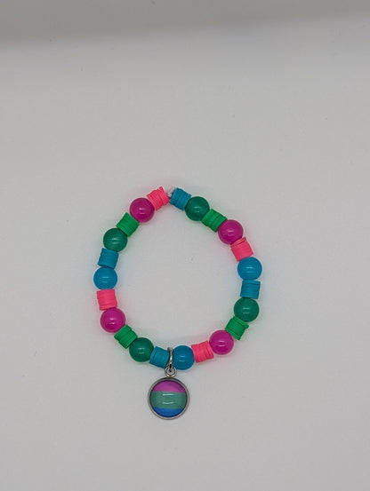 Colorful beaded bracelet with a circular charm on a white background