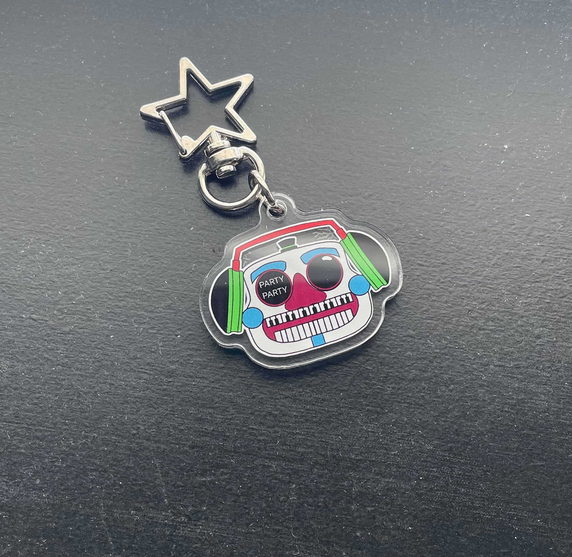Keychain with a colorful design on a dark surface