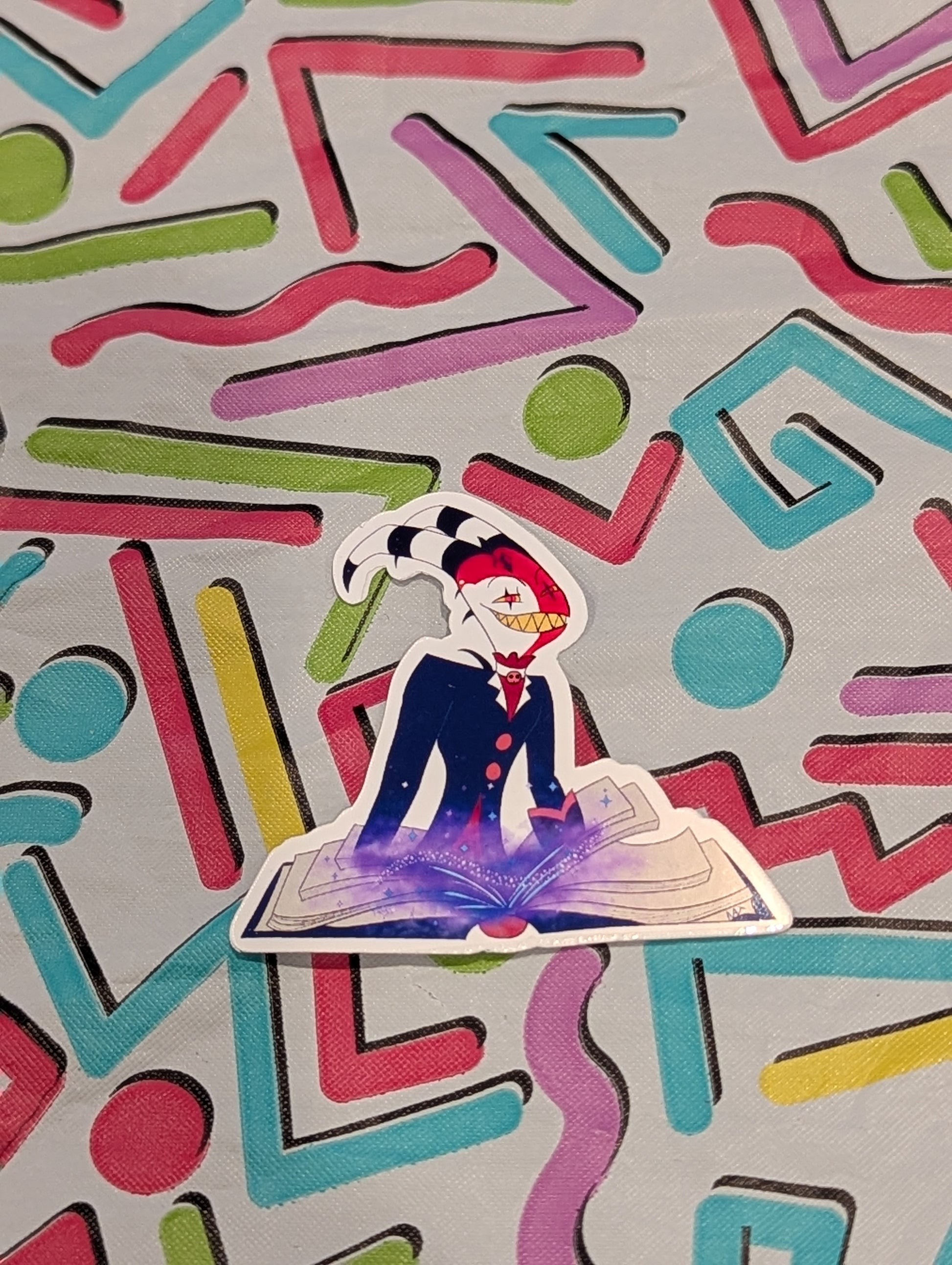 Sticker of a character with a colorful geometric pattern in the background