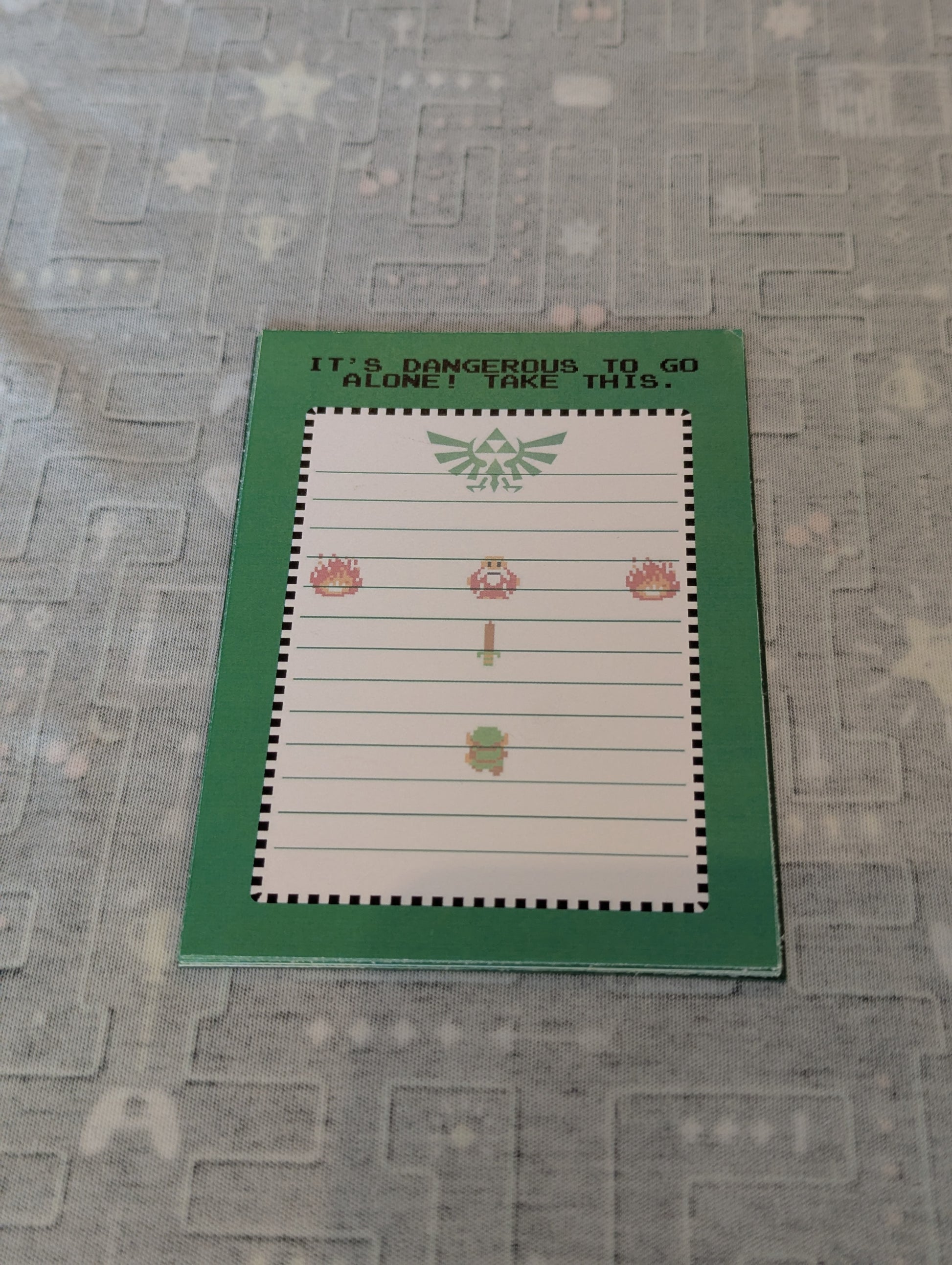 Notebook with Legend of Zelda design on a textured surface