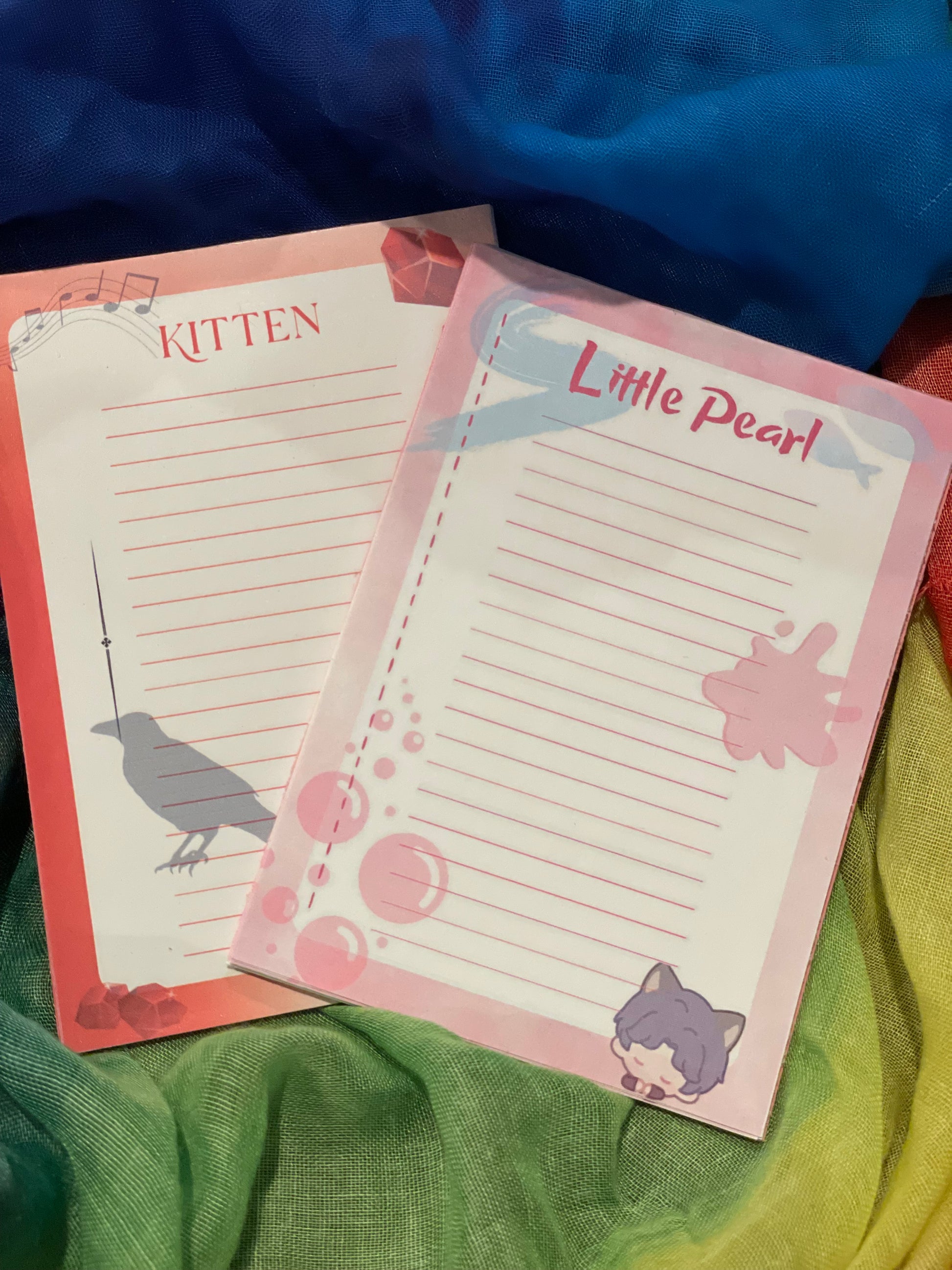 Notebook with 'Little Pearl' and 'Kitten' design on a colorful background