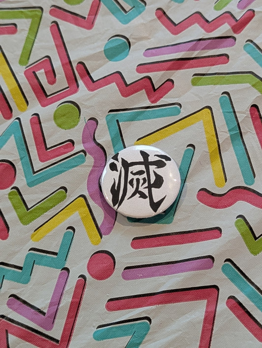 Demon Slayer Button with black text on a colorful geometric patterned background