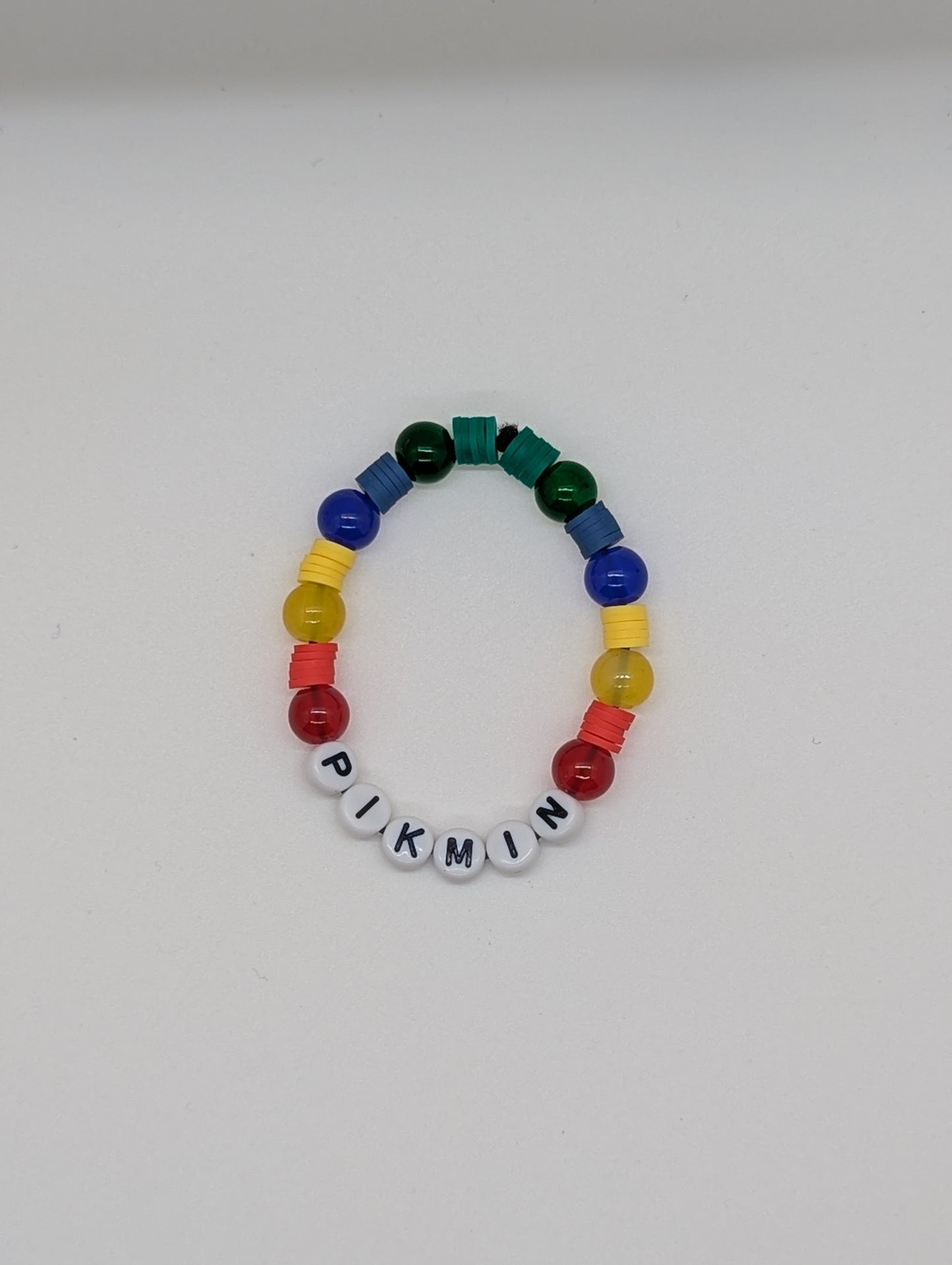 Colorful beaded bracelet with 'PIKMIN' letters on a white background