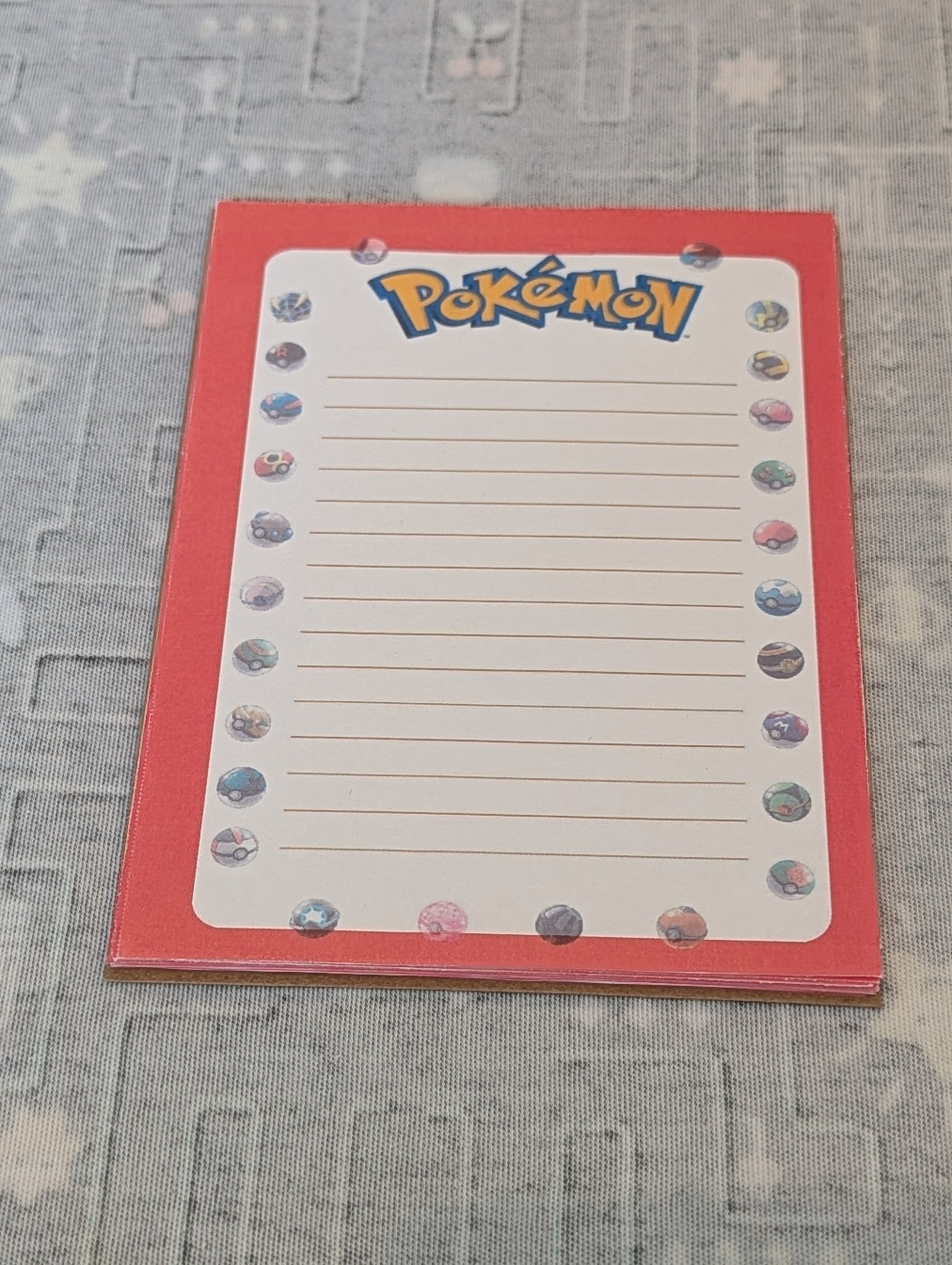 Notepad with Pokemon branding on a textured surface