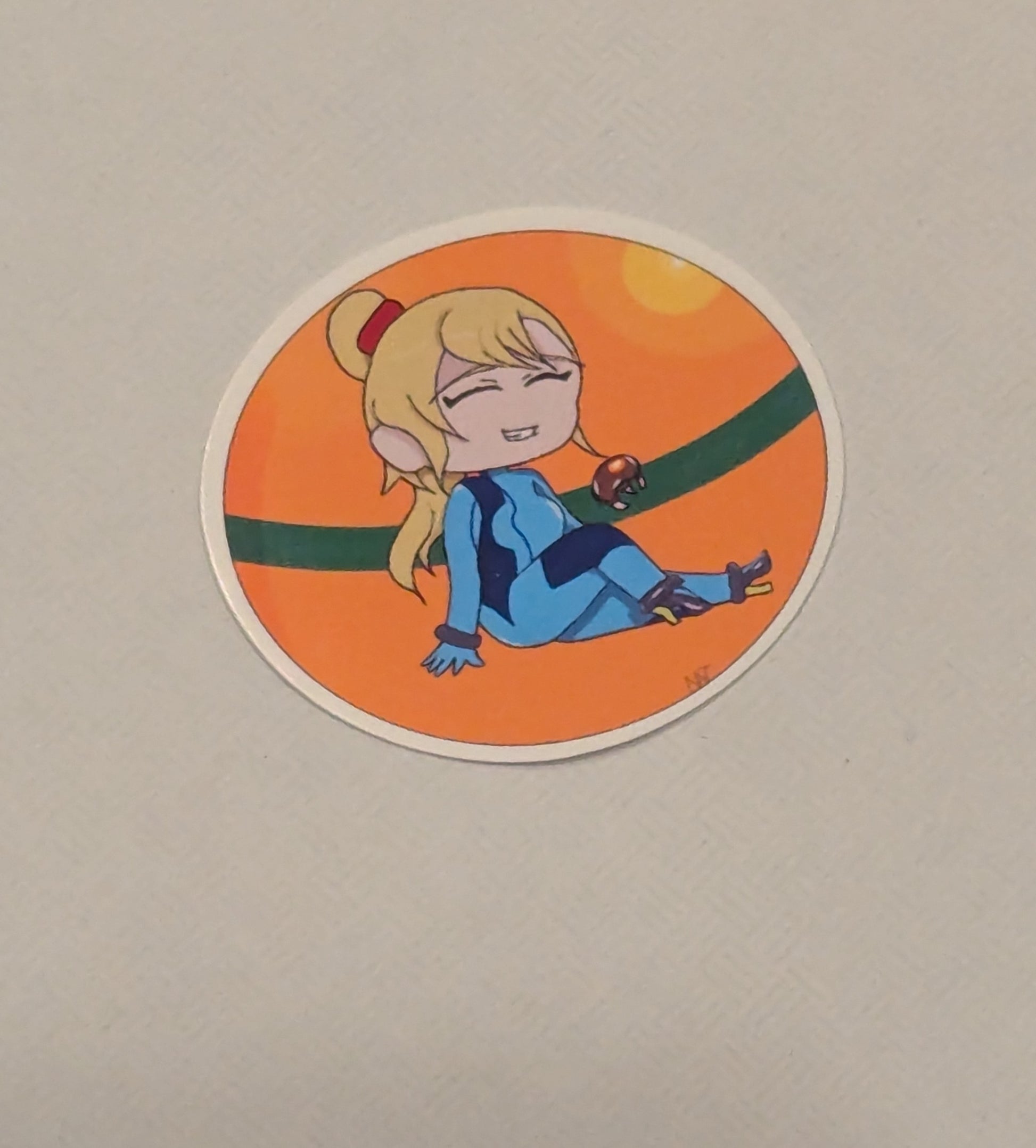Circular sticker with a character in blue outfit on an orange background