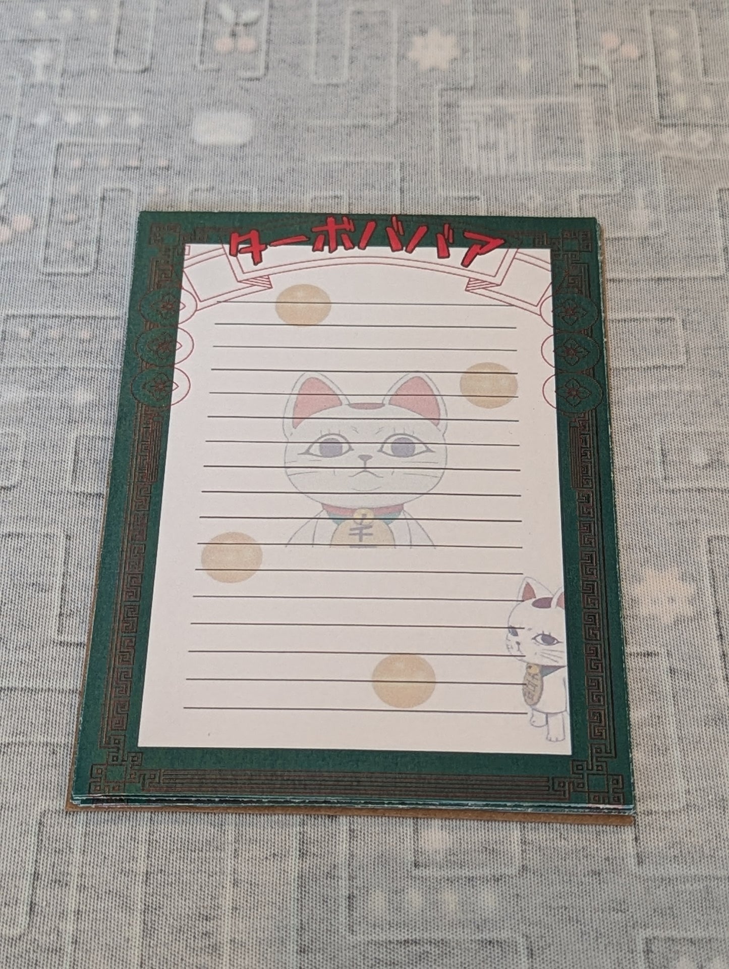 Notebook with a cat illustration on a textured surface