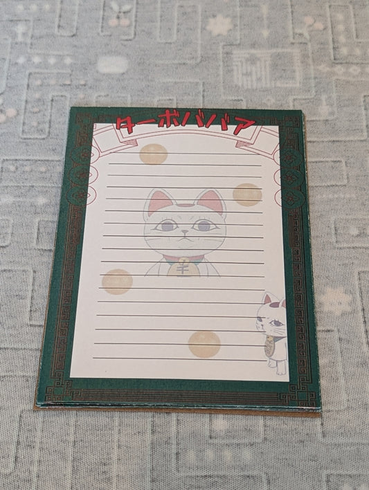 Notebook with a cat illustration on a textured surface