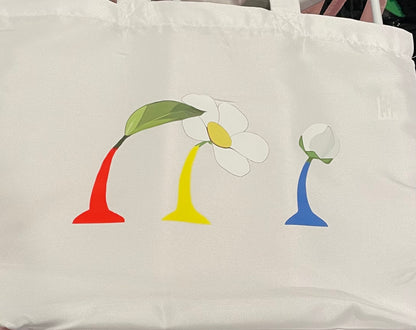White tote bag with colorful flower design on a white background