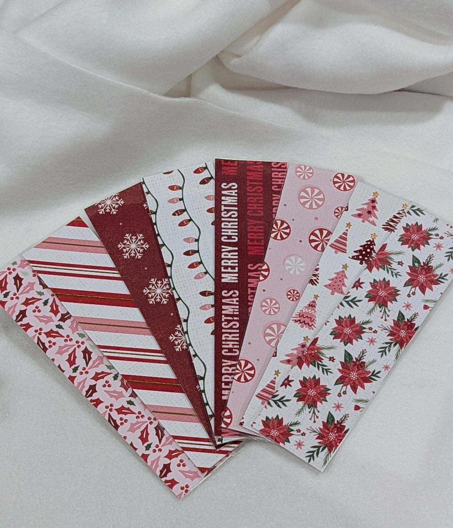 Set of Christmas-themed stationery items on a white fabric background