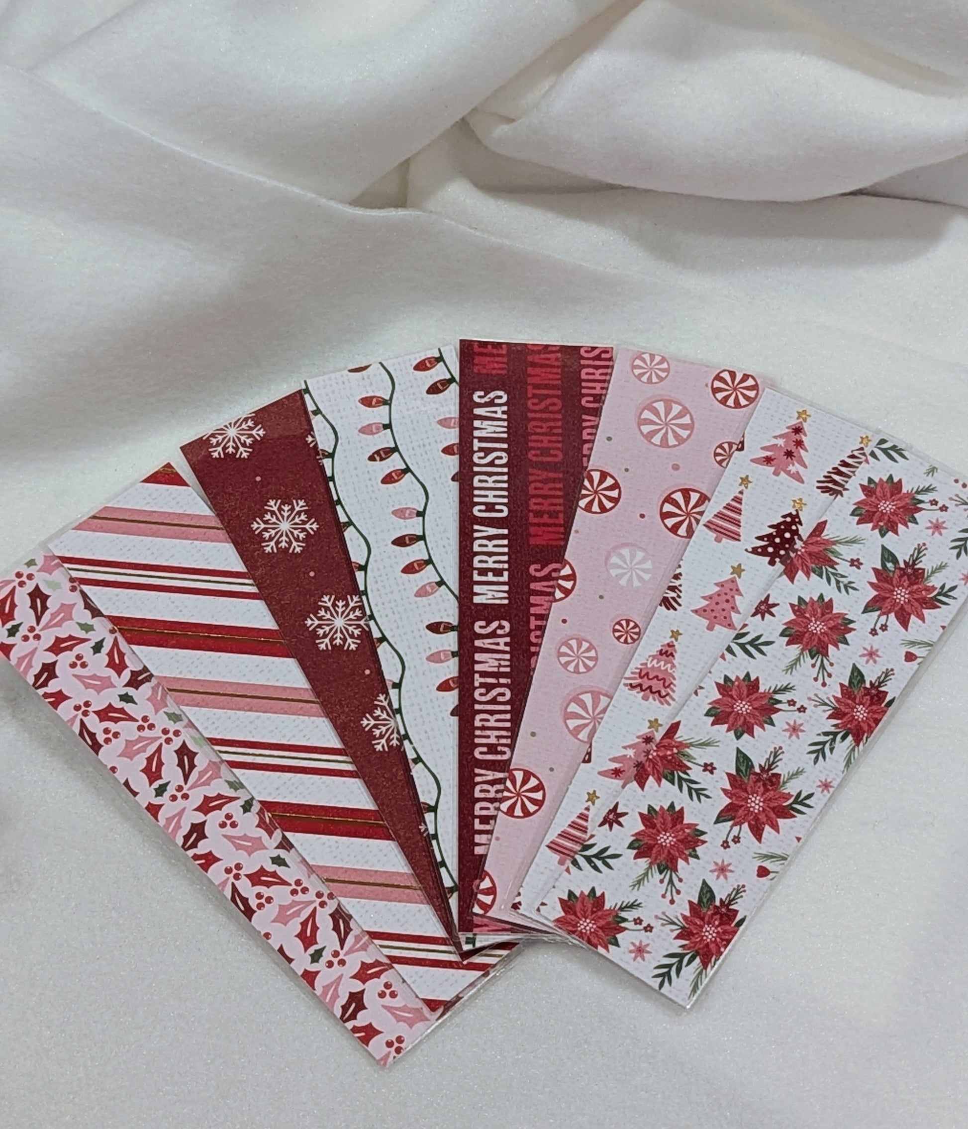 Set of Christmas-themed stationery items on a white fabric background